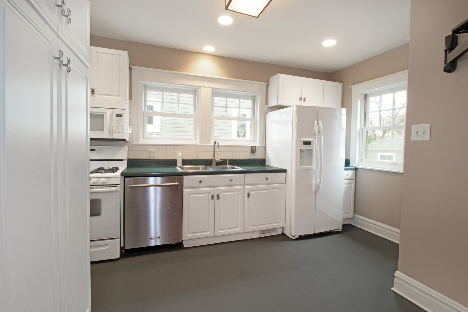 261 Blackhawk Road Riverside, IL 60546 - Photo 12 of 31 a kitchen with stainless steel appliances a refrigerator sink and cabinets