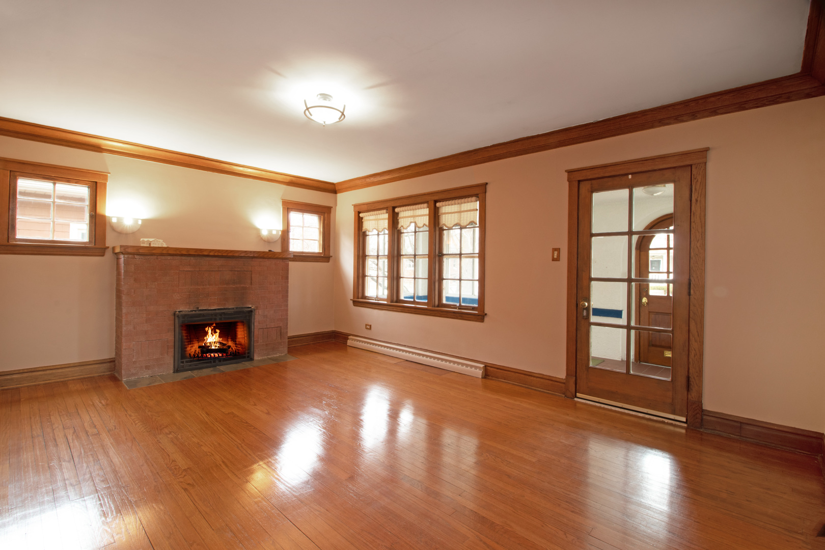 261 Blackhawk Road Riverside, IL 60546 - Photo 3 of 31 a view of an empty room with wooden floor fireplace and a window