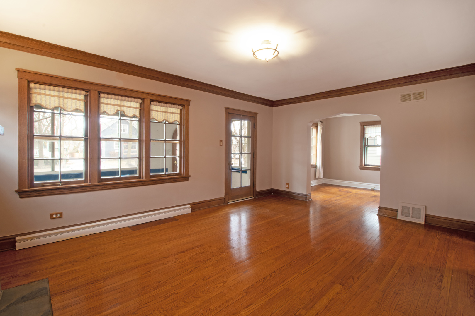 261 Blackhawk Road Riverside, IL 60546 - Photo 4 of 31 a view of an empty room with wooden floor and a window