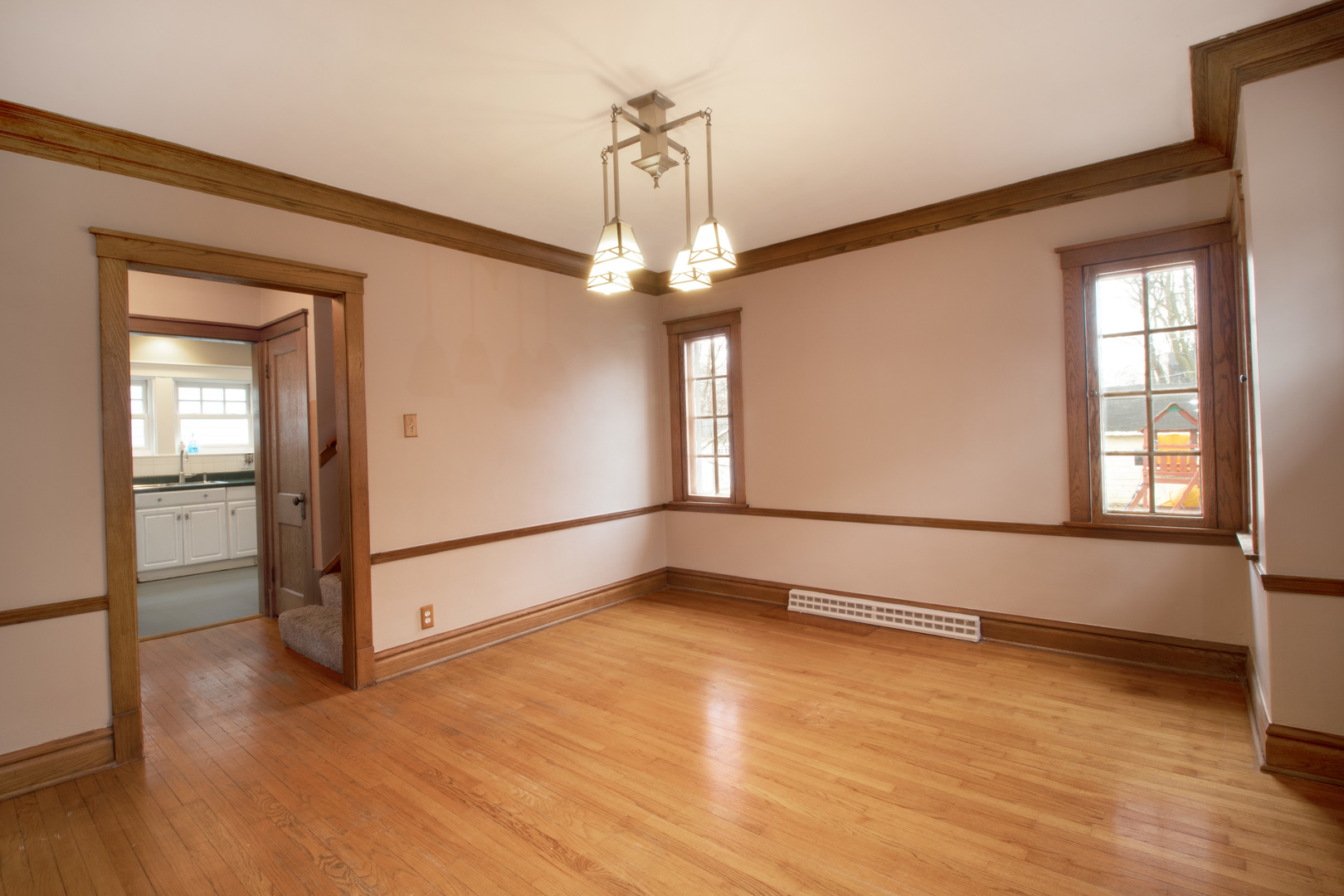 261 Blackhawk Road Riverside, IL 60546 - Photo 7 of 31 a view of an empty room with wooden floor and a window