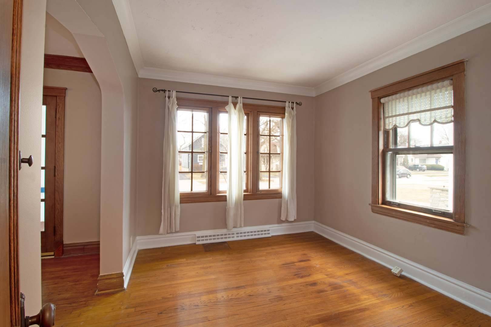 261 Blackhawk Road Riverside, IL 60546 - Photo 9 of 31 a view of empty room with wooden floor and fan