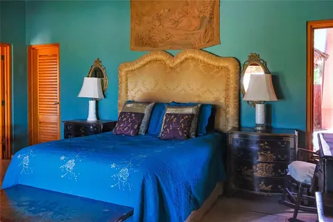 a bedroom with a bed and a lamp