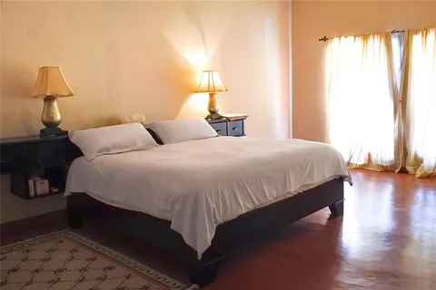 a bedroom with a bed and a lamp