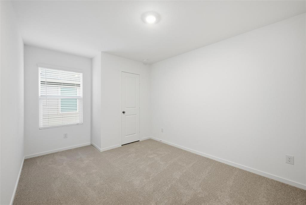 1037 Raintree Road Princeton, TX 75407 - Photo 11 of 21 an empty room with windows