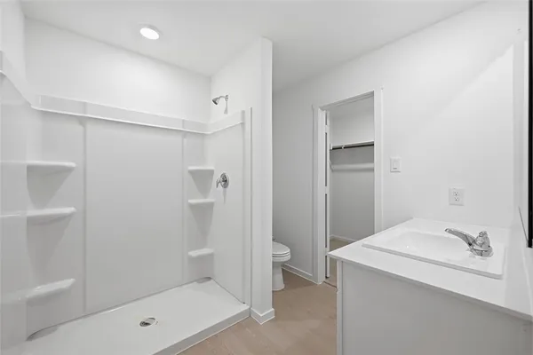 a bathroom with a tub sink toilet and shower