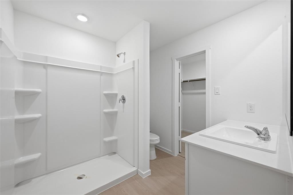 1037 Raintree Road Princeton, TX 75407 - Photo 13 of 21 a bathroom with a tub sink toilet and shower