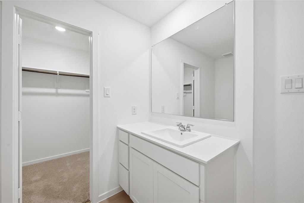 1037 Raintree Road Princeton, TX 75407 - Photo 14 of 21 a bathroom with a sink and a mirror