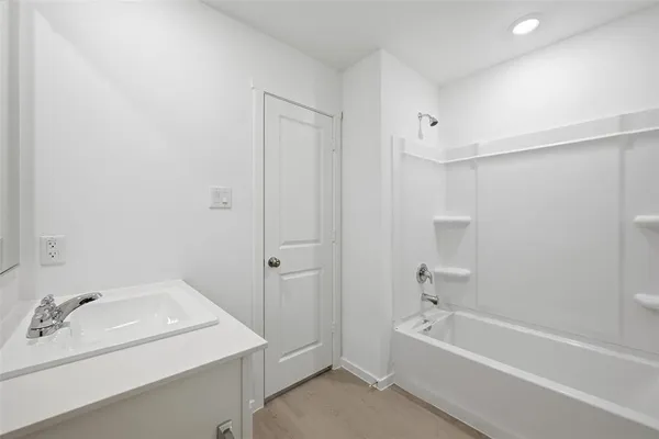 a bathroom with a bathtub a sink and a shower
