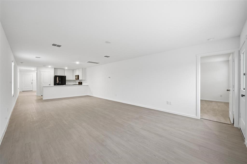 1037 Raintree Road Princeton, TX 75407 - Photo 2 of 21 a view of a kitchen with a sink and a stove