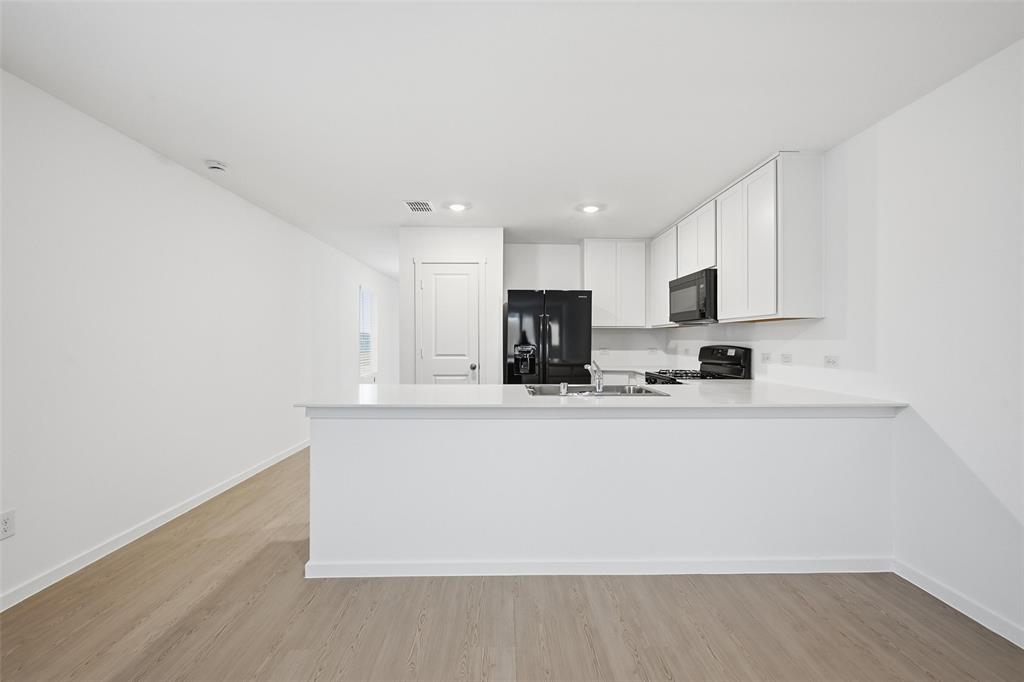 1037 Raintree Road Princeton, TX 75407 - Photo 5 of 21 a view of kitchen with stainless steel appliances granite countertop refrigerator sink and stove