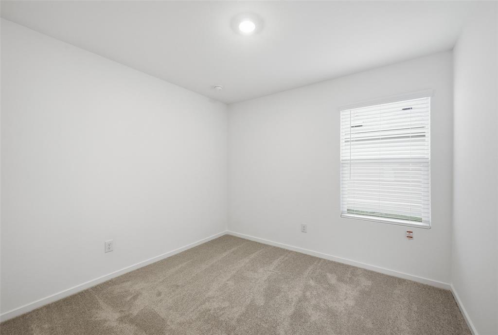 1037 Raintree Road Princeton, TX 75407 - Photo 8 of 21 an empty room with a window
