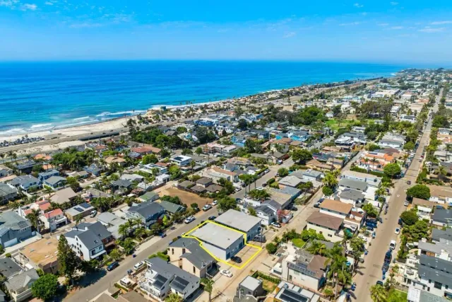 an aerial view of residential building and ocean