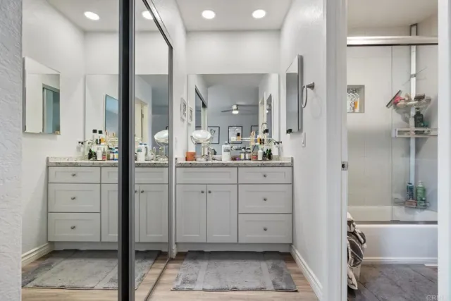 a spacious bathroom with a shower sink and mirror