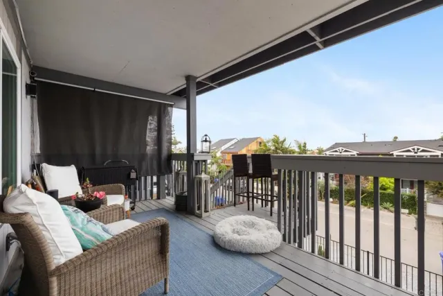 a balcony with wooden floor and furniture