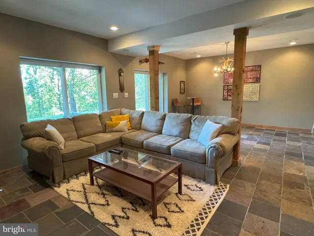 a view of a room with a chandelier fan and windows