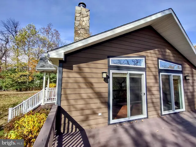 a view of balcony with wooden floor and fence