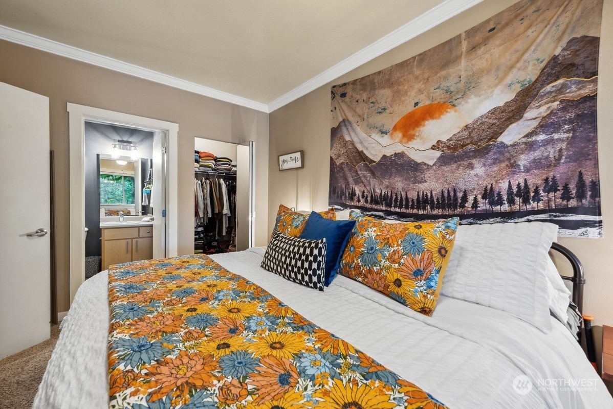 10709 Valley View Road, Unit C103 Bothell, WA 98011 - Photo 17 of 30 a bedroom with a bed and dresser with mirror
