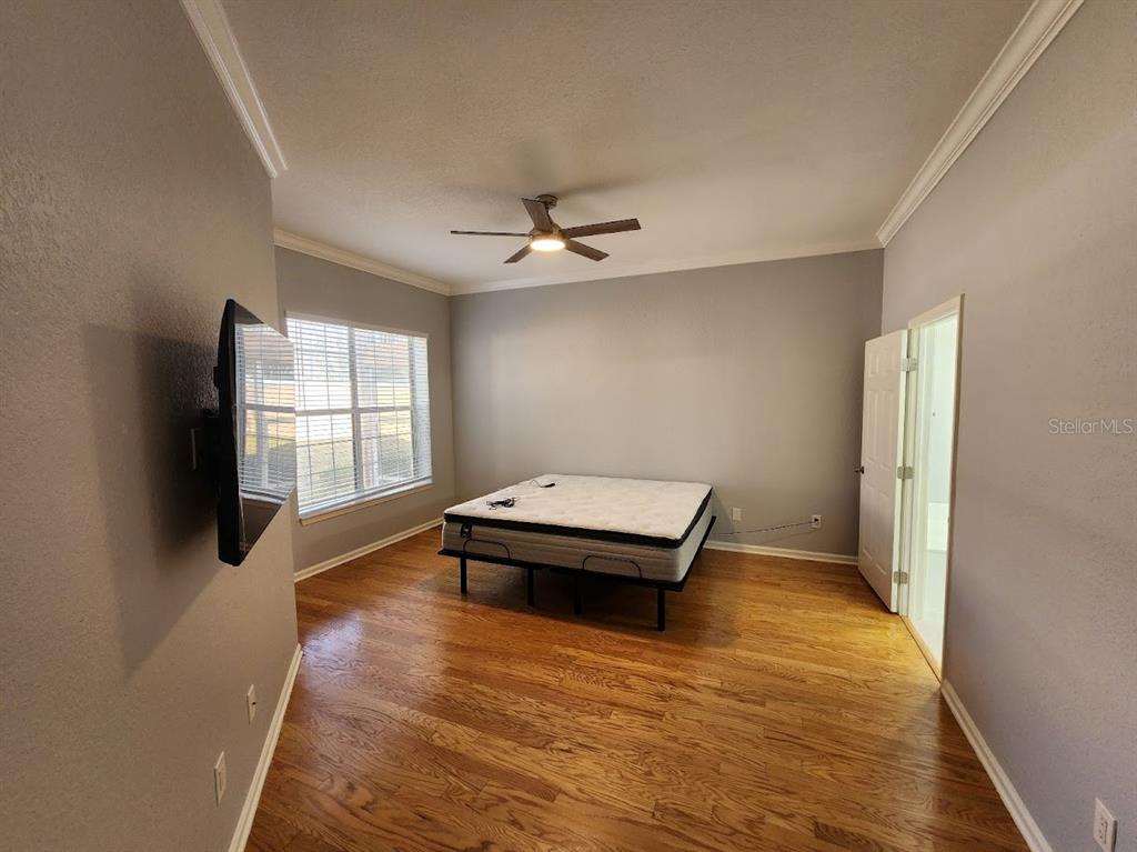 7511 Bayport Road, Unit 5 Orlando, FL 32819 - Photo 12 of 26 wooden floor in an empty room with a window