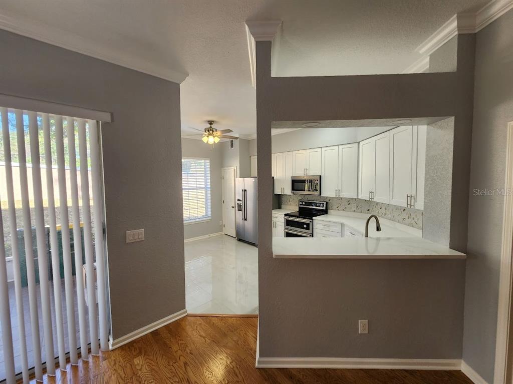 7511 Bayport Road, Unit 5 Orlando, FL 32819 - Photo 6 of 26 a view of a kitchen with a sink and a refrigerator