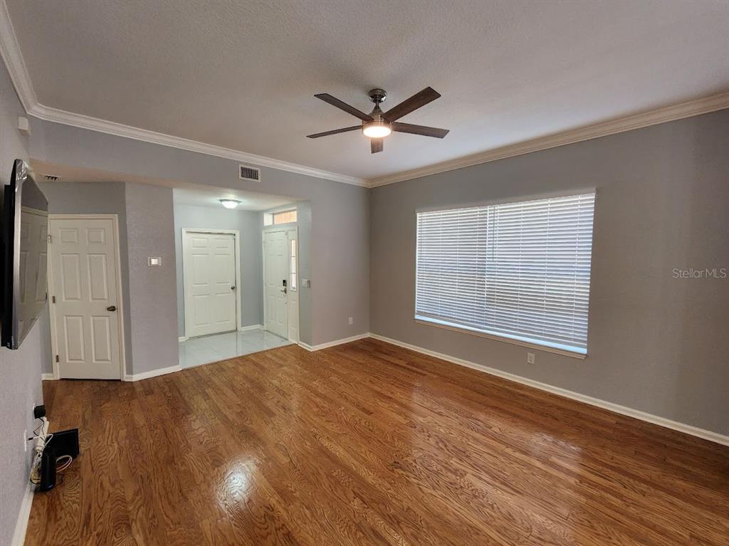 7511 Bayport Road, Unit 5 Orlando, FL 32819 - Photo 7 of 26 a view of an empty room with wooden floor and a window