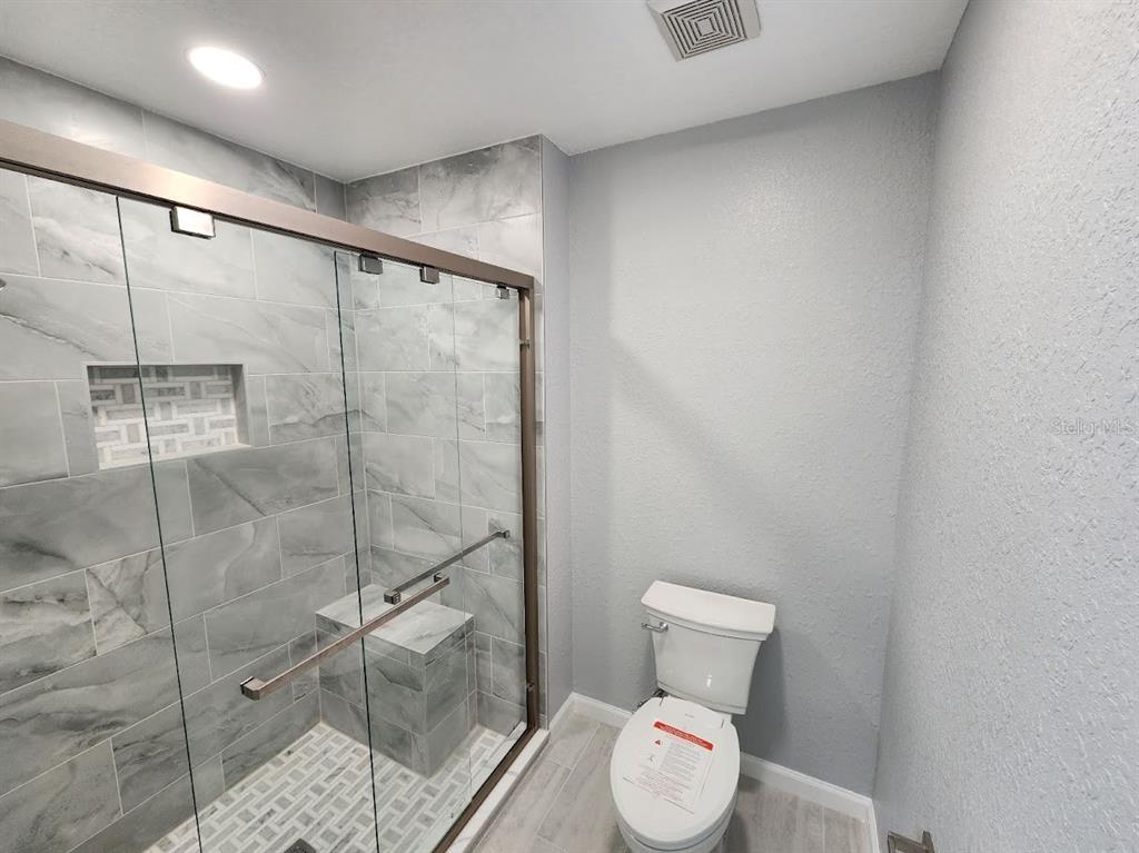 7511 Bayport Road, Unit 5 Orlando, FL 32819 - Photo 10 of 26 a bathroom with a toilet and a shower