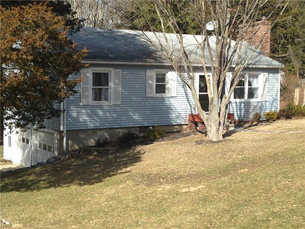 a front view of a house with a yard covered with snow