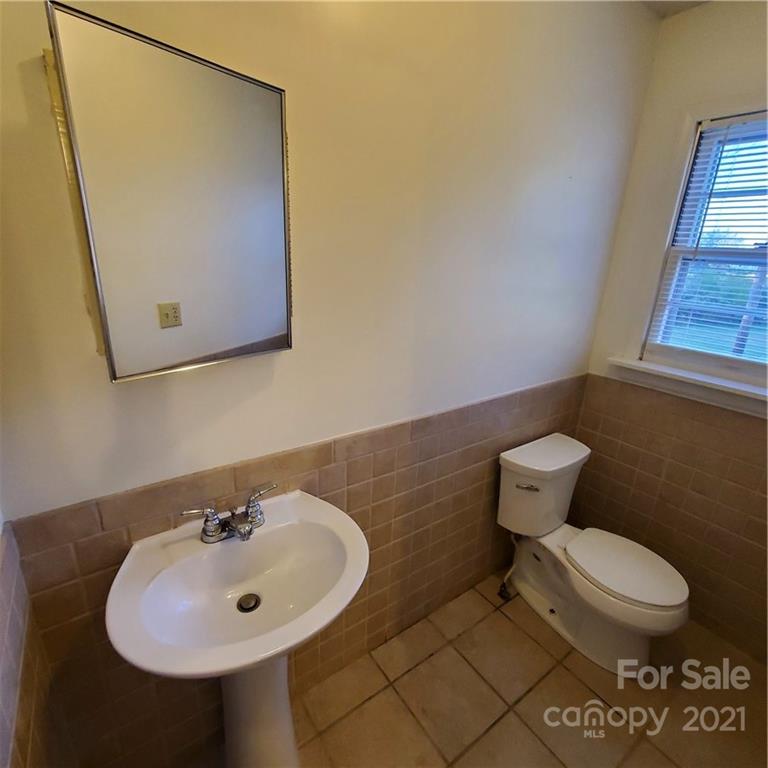 217 McBride Lumber Road Star, NC 27356 - Photo 14 of 16 a bathroom with a sink a toilet and mirror
