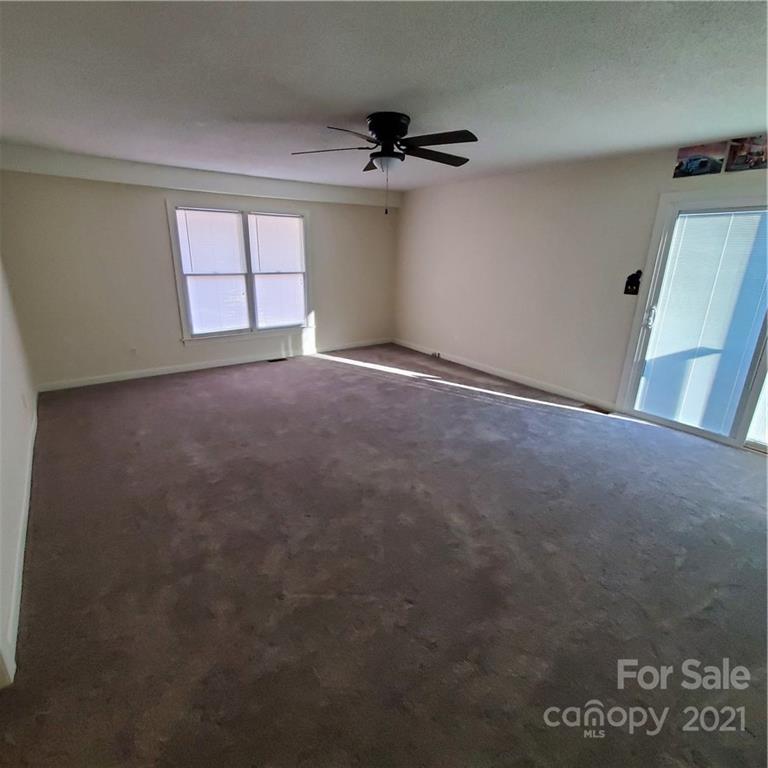 217 McBride Lumber Road Star, NC 27356 - Photo 8 of 16 an empty room with a ceiling fan and window