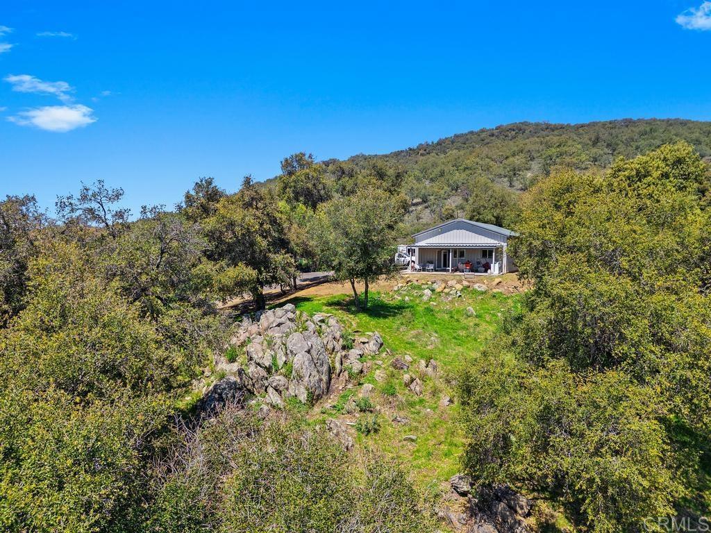25677 Mesa Grande Road Santa Ysabel, CA 92070 - Photo 9 of 28 a view of a building with a mountain in the background