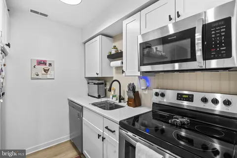 a kitchen with a stove and a microwave