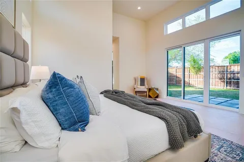 a bedroom with bed and a large window