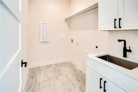a view of a kitchen with a sink and refrigerator