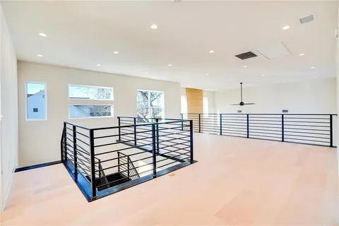 a spacious bedroom with a bed and a large window