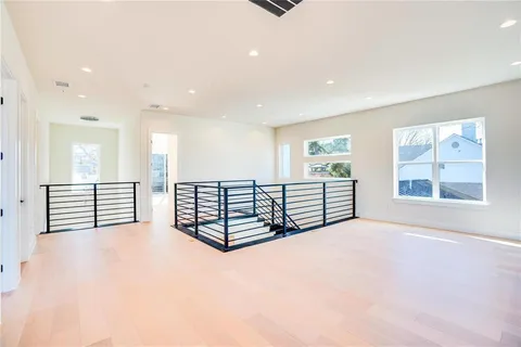 a view of a big room with windows and cabinet