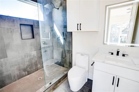 a bathroom with a sink toilet and shower