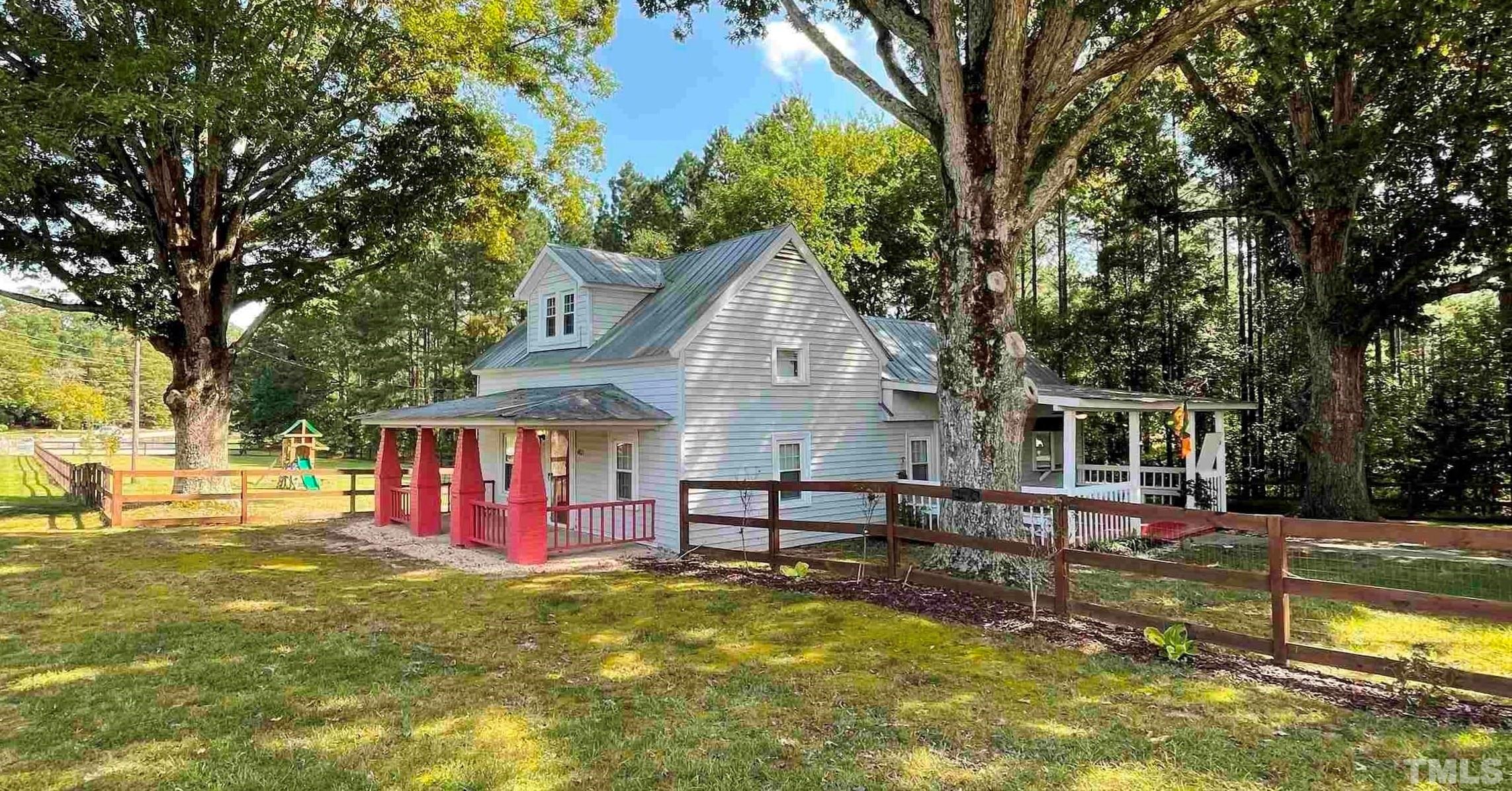 a view of swimming pool with a backyard and trees