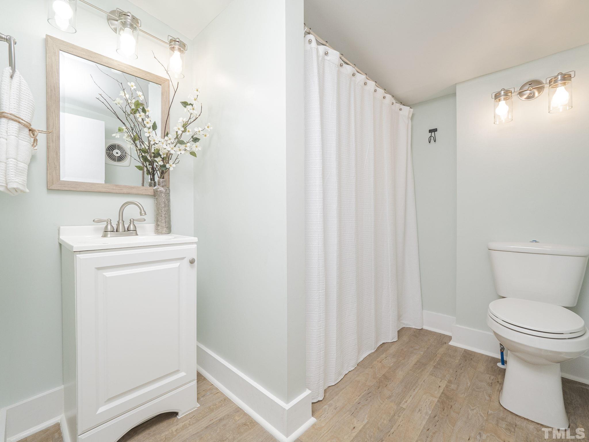4821 Purnell Road Wake Forest, NC 27587 - Photo 17 of 19 a bathroom with a sink a toilet and shower curtain
