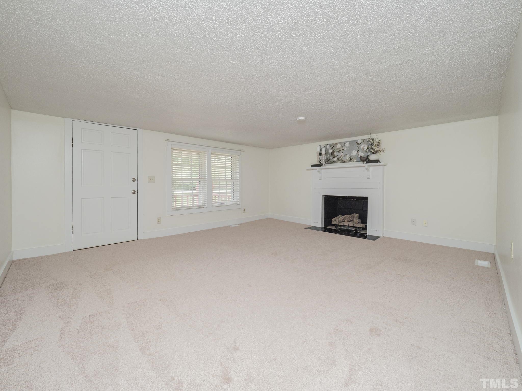 4821 Purnell Road Wake Forest, NC 27587 - Photo 18 of 19 a view of empty room with a fireplace