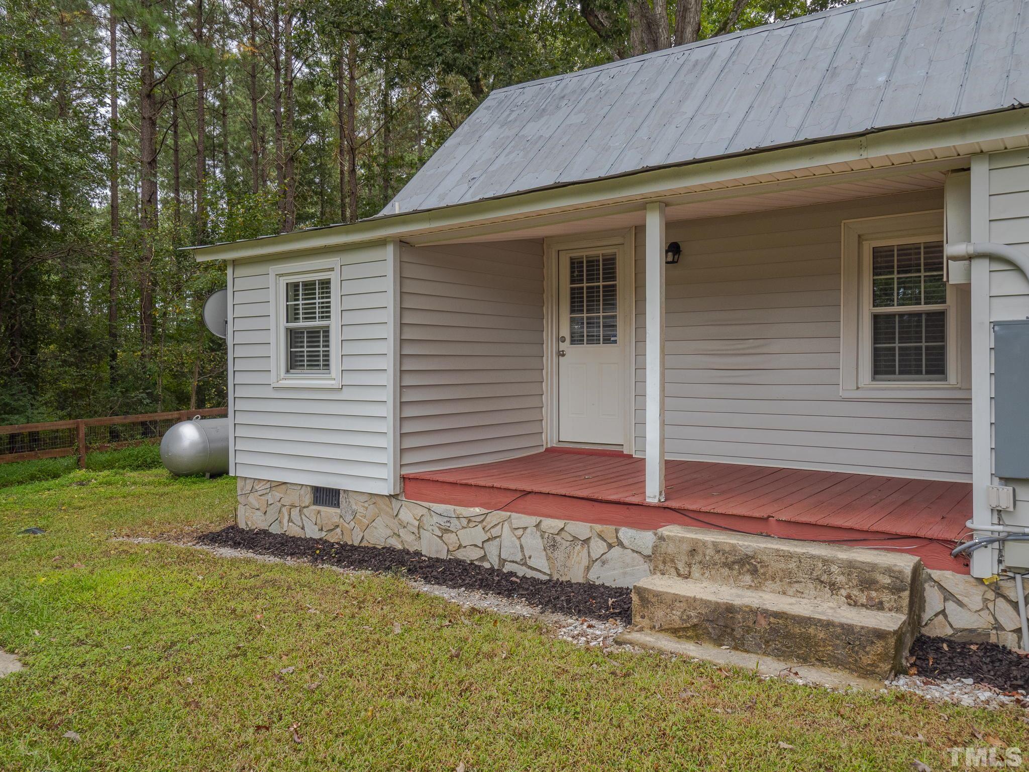 4821 Purnell Road Wake Forest, NC 27587 - Photo 6 of 19 a backyard of a house with wooden fence and large trees