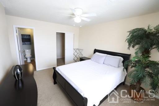 936 Edpas Road New Brunswick, NJ 08901 - Photo 12 of 18 a spacious bedroom with a bed and a chandelier