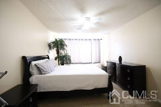 936 Edpas Road New Brunswick, NJ 08901 - Photo 14 of 18 a bedroom with a bed and a chandelier