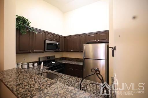 936 Edpas Road New Brunswick, NJ 08901 - Photo 7 of 18 a kitchen with a refrigerator and a stove top oven