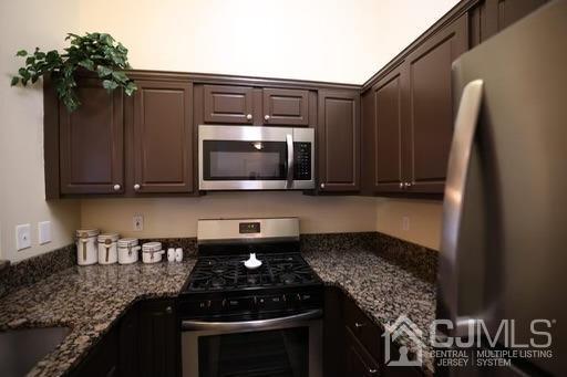 936 Edpas Road New Brunswick, NJ 08901 - Photo 9 of 18 a kitchen with granite countertop a stove and a microwave