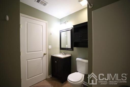 936 Edpas Road New Brunswick, NJ 08901 - Photo 10 of 18 a bathroom with a granite countertop toilet sink and mirror