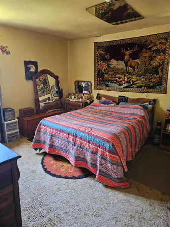 a room with lots of wooden furniture and a baby crib