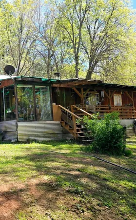 a view of a house with backyard and sitting area
