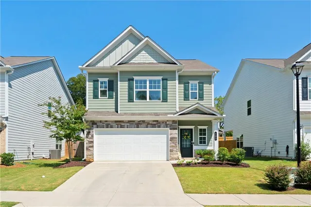 a front view of a house with a yard and garage