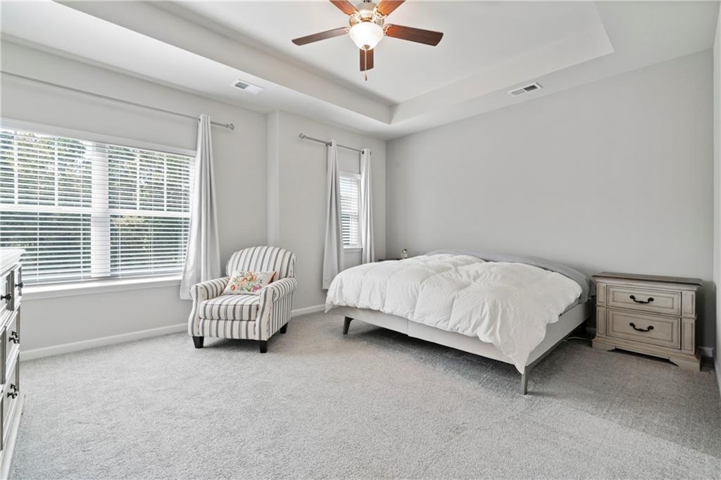 103 Waterside Drive Calhoun, GA 30701 - Photo 23 of 48 a bedroom with a white bed and a chandelier