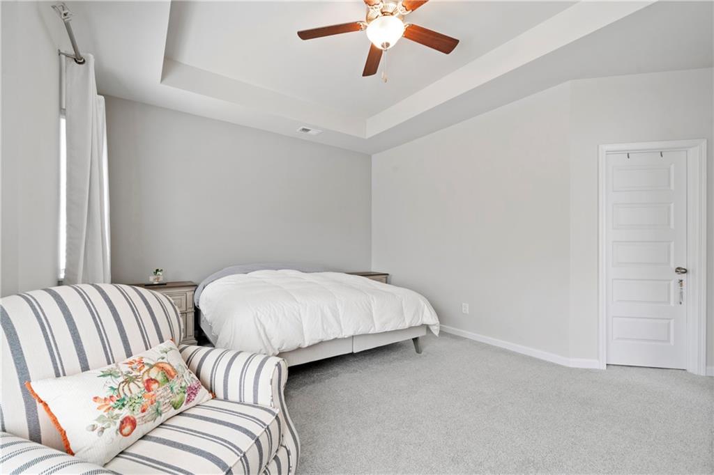 103 Waterside Drive Calhoun, GA 30701 - Photo 25 of 48 a bedroom with a bed and a chandelier