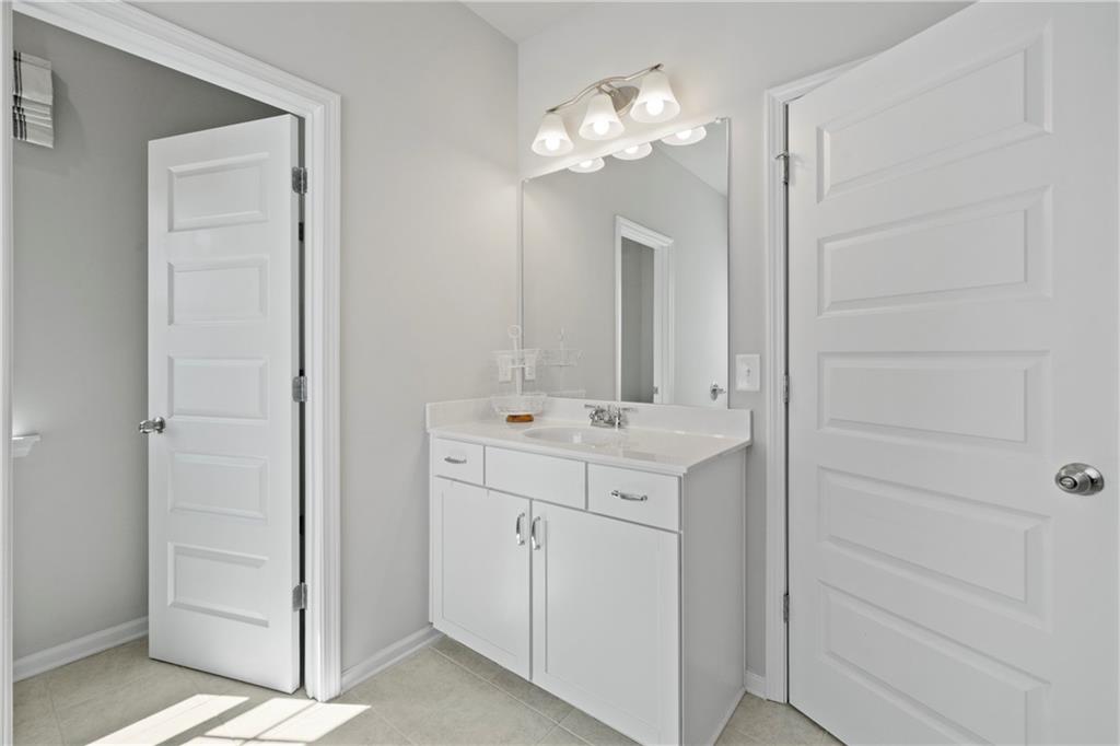 103 Waterside Drive Calhoun, GA 30701 - Photo 27 of 48 a bathroom with a sink vanity and a mirror